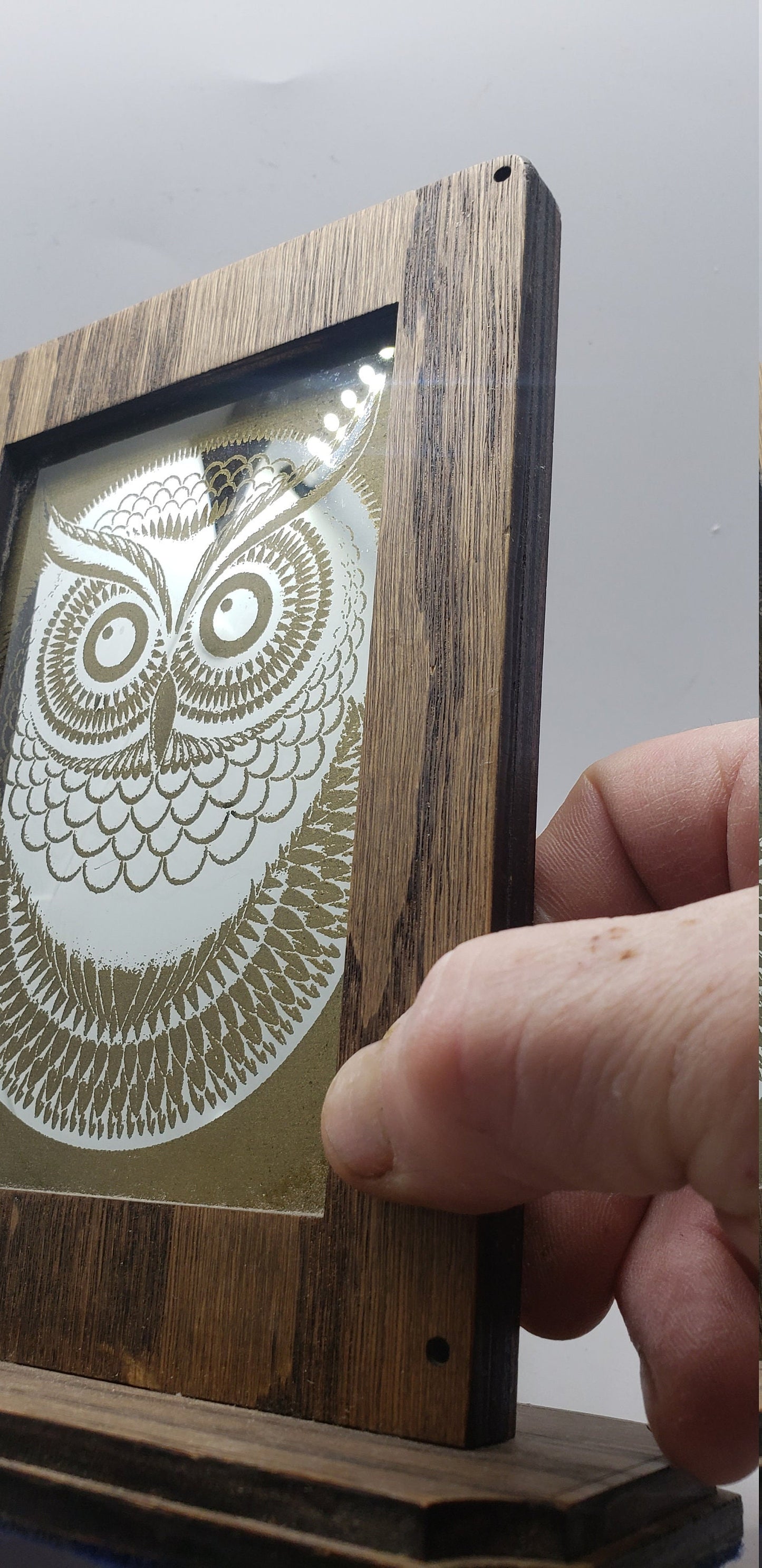 Laser Etched Owl Mirror: Oak Wood Frame, Gold Accents. An oak-framed mirror with owl engraving, compact, elegant, made from fireplace relic.