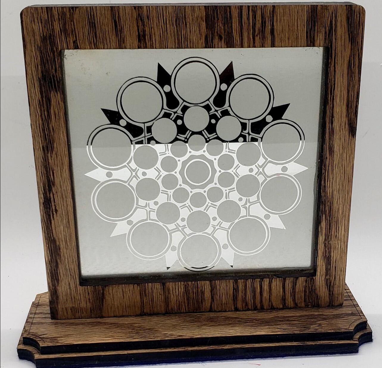 This unique abstract laser etching on a mirror creates captivating, modern art. The intricate design transforms into a stunning focal point.