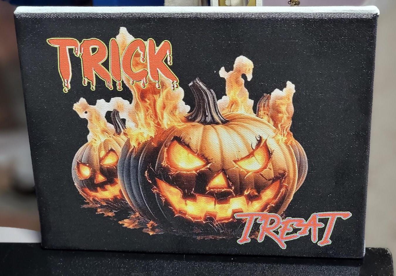 Trick or Treat” 8x10 Canvas—fiery jack-o'-lanterns & bold UV print bring Halloween heat to your décor. Spooky charm, delivered! Scary
