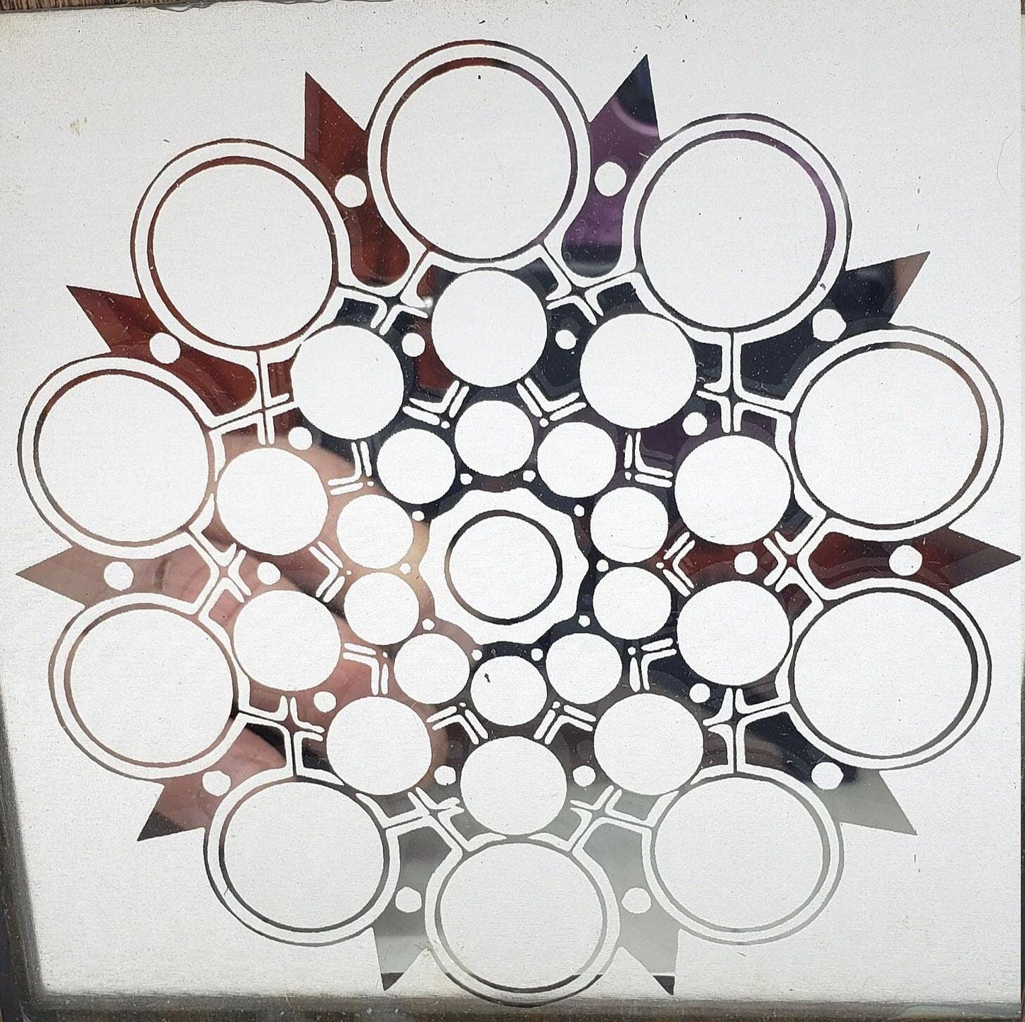 This unique abstract laser etching on a mirror creates captivating, modern art. The intricate design transforms into a stunning focal point.