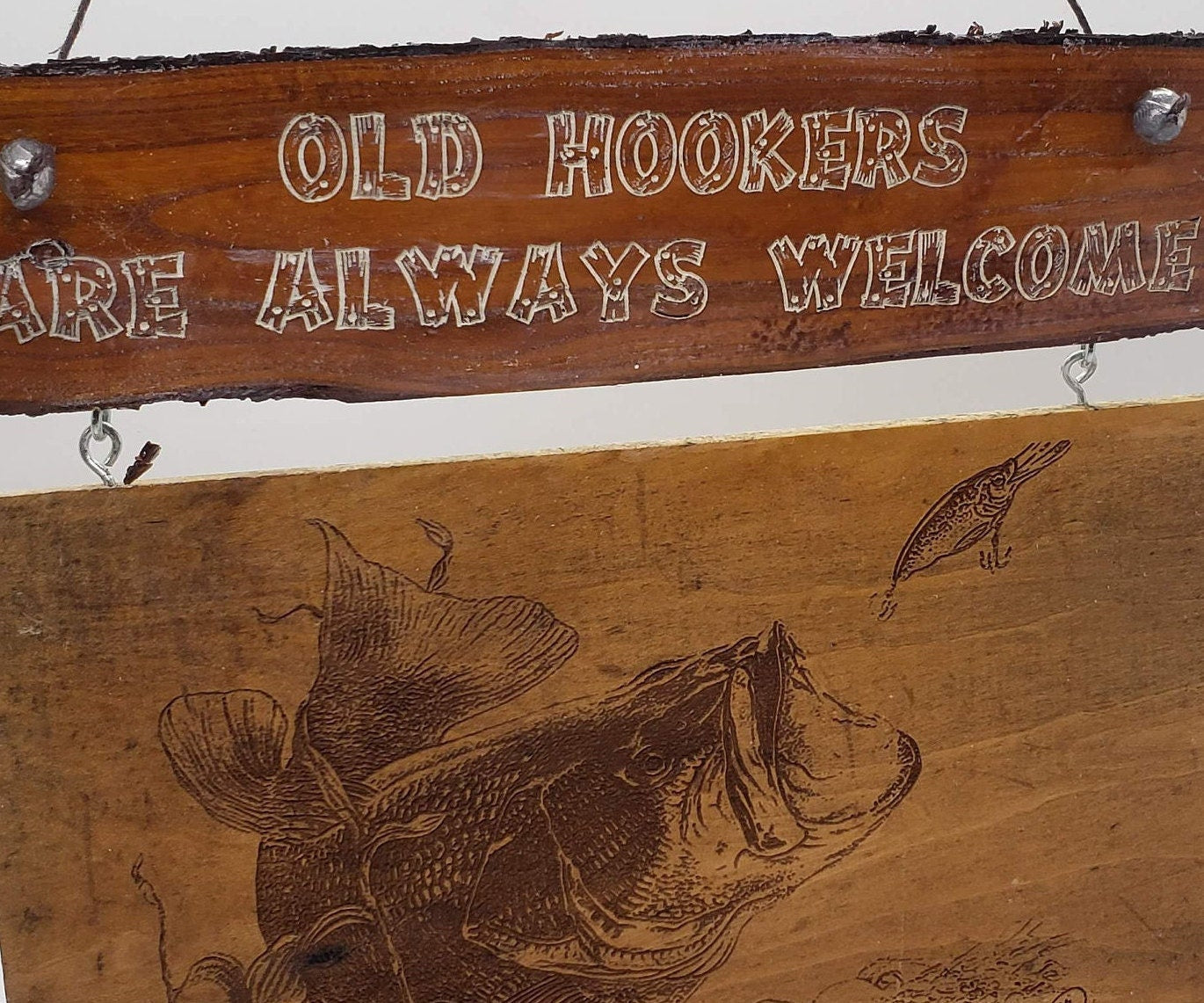 This is a funny sign that would look great on the front door of a cabin or a lakeside bar. It features the words "Old Hookers Welcome"!