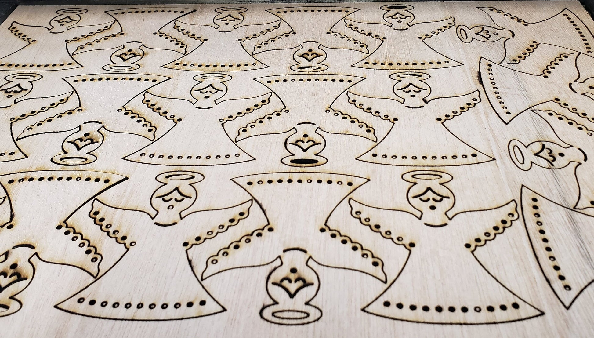 Gracefully carved with a minimalist elegance, this wooden angel radiates peace and holiday cheer. Her closed eyes and gentle smile evoke a sense of calm and quiet joy, while the halo above her head adds a touch of celestial reverence. Outstretched wings, adorned with circular cut-out patterns, frame her figure like a protective embrace. The robe flows downward in soft curves, echoing the wing motif with matching circular accents along the hem. Boldly etched across the bottom.