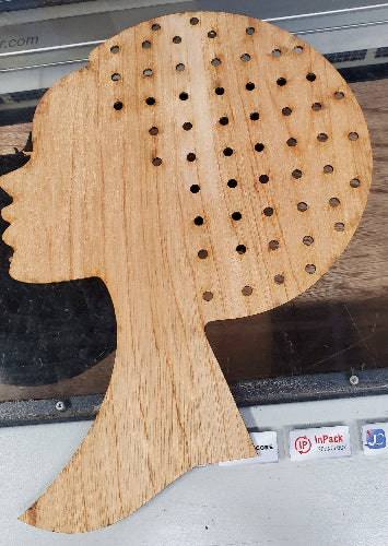 Detailed description of the product: a meticulously crafted wooden pegboard head silhouette, featuring strategically placed holes for versatile display options. Constructed from high-quality birch plywood, precisely measured at 1/8" thickness for optimal durability and ease of handling. The silhouette is artfully designed and presented on a sturdy, complementary display stand, enhancing its visual appeal and ensuring a professional