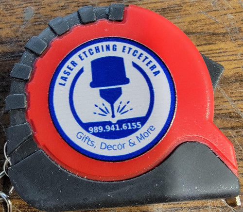 I used my laser to cut 1-inch removable sticky paper. Then I placed a sticker on each test run to check position. After the test, I simply pealed off the label.
DIGITAL FILE__Use the Mutoh 661 UV Printer and CompressRip setup to ensure that your mini tape measures are securely held during the printing and handling phases. For added protection, consider using a material that’s both ink and UV-resistant, like coated plywood or MDF with a protective finish.