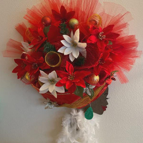 Decorative headpiece with red flowers, white poinsettias, and gold ornaments on a plain background