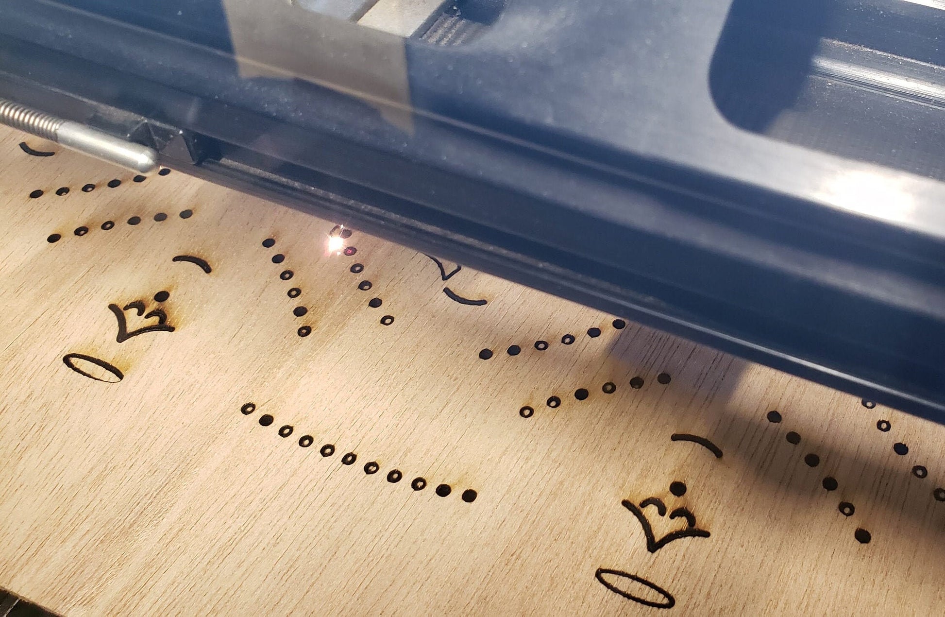 Gracefully carved with a minimalist elegance, this wooden angel radiates peace and holiday cheer. Her closed eyes and gentle smile evoke a sense of calm and quiet joy, while the halo above her head adds a touch of celestial reverence. Outstretched wings, adorned with circular cut-out patterns, frame her figure like a protective embrace. The robe flows downward in soft curves, echoing the wing motif with matching circular accents along the hem. Boldly etched across the bottom.