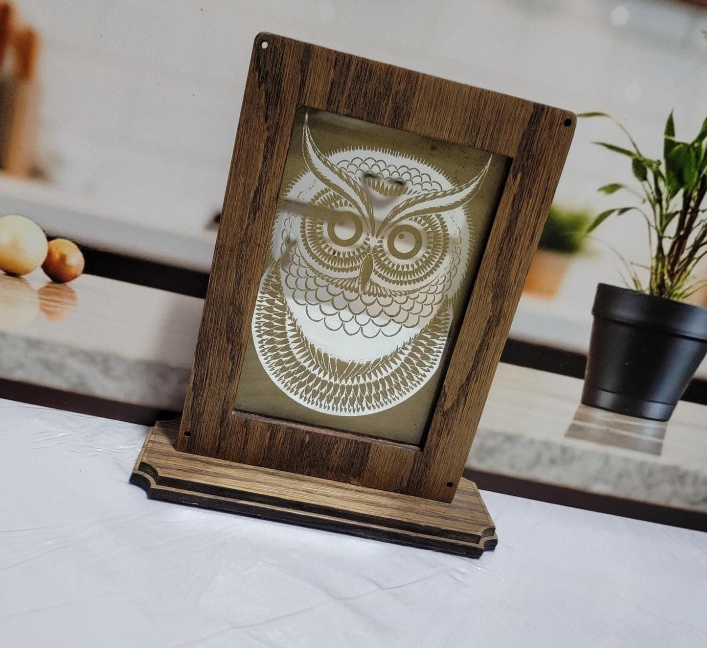 Laser Etched Owl Mirror: Oak Wood Frame, Gold Accents. An oak-framed mirror with owl engraving, compact, elegant, made from fireplace relic.