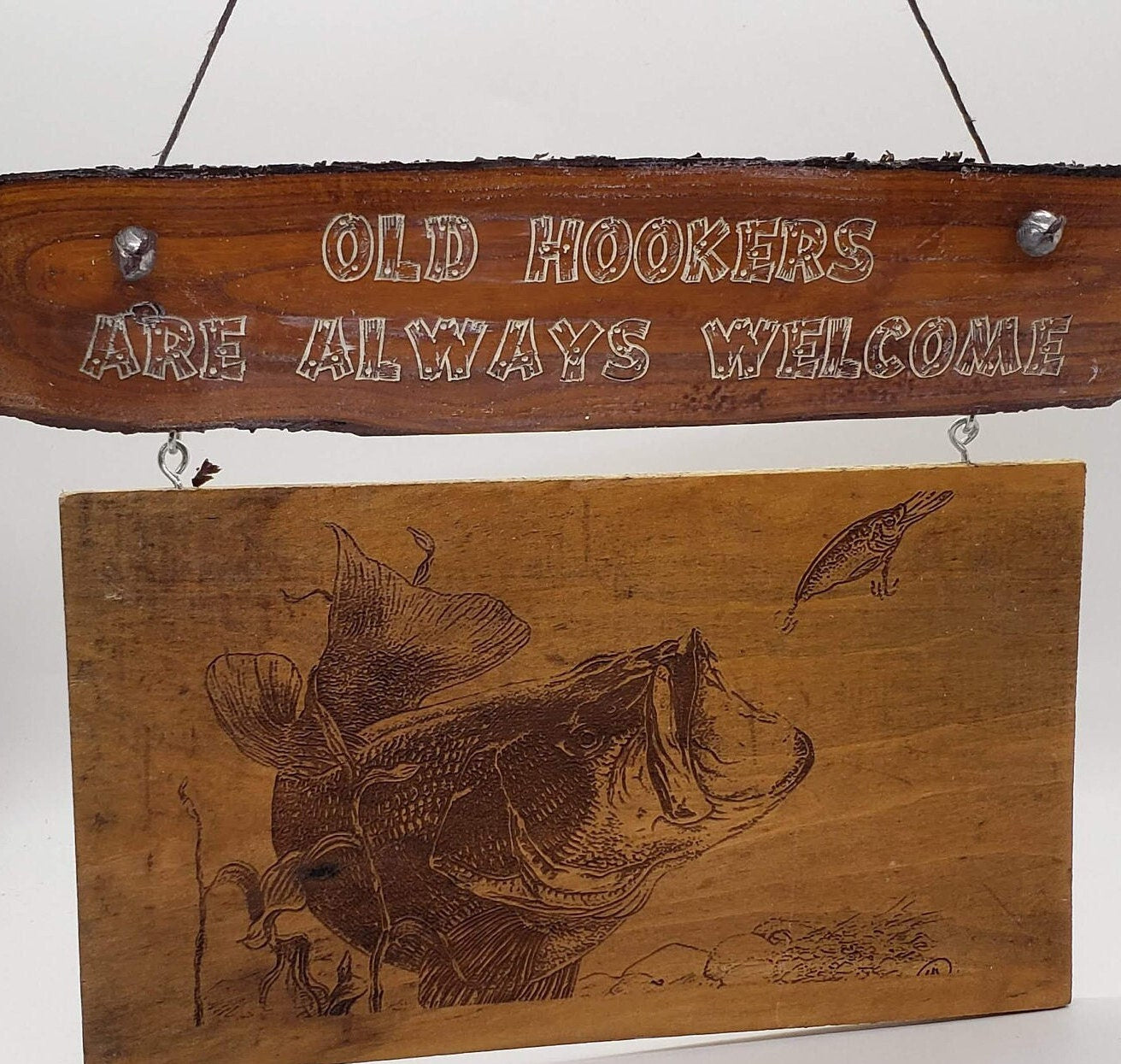 This is a funny sign that would look great on the front door of a cabin or a lakeside bar. It features the words "Old Hookers Welcome"!