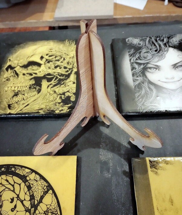 Laser-engraved tiles—spooky, steampunk, on clearance! Each piece is unique, handmade, & comes with a free stand. Limited stock! Buy and save