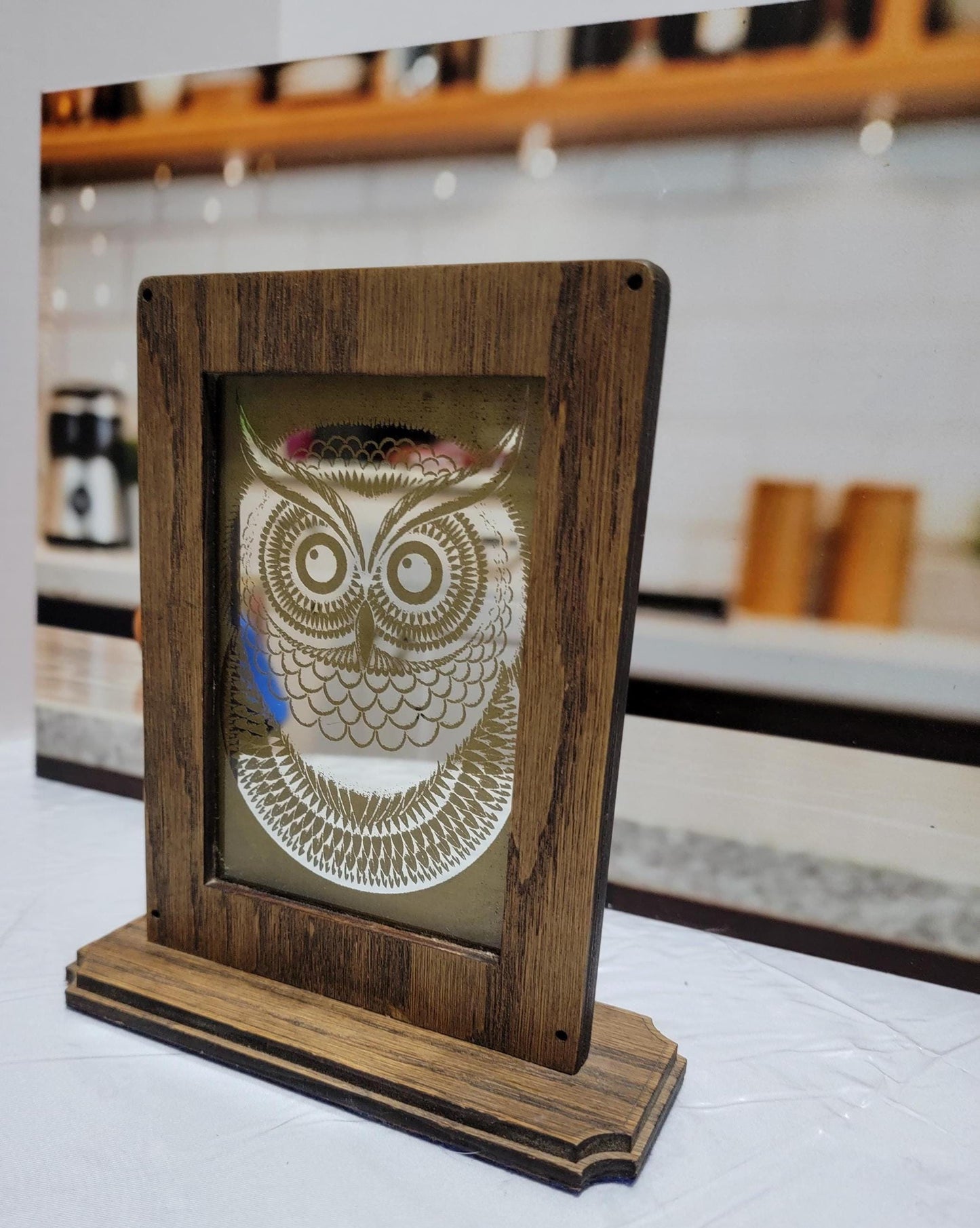 Laser Etched Owl Mirror: Oak Wood Frame, Gold Accents. An oak-framed mirror with owl engraving, compact, elegant, made from fireplace relic.