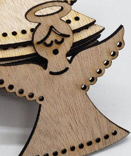 Gracefully carved with a minimalist elegance, this wooden angel radiates peace and holiday cheer. Her closed eyes and gentle smile evoke a sense of calm and quiet joy, while the halo above her head adds a touch of celestial reverence. Outstretched wings, adorned with circular cut-out patterns, frame her figure like a protective embrace. The robe flows downward in soft curves, echoing the wing motif with matching circular accents along the hem. Boldly etched across the bottom.