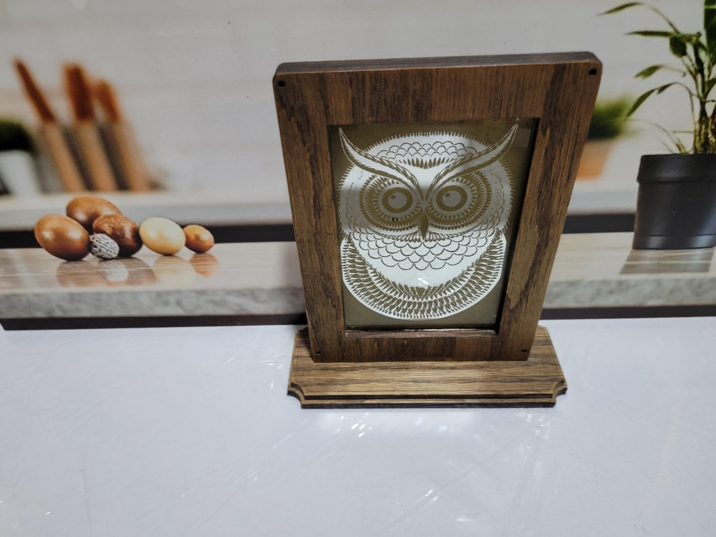 Laser Etched Owl Mirror: Oak Wood Frame, Gold Accents. An oak-framed mirror with owl engraving, compact, elegant, made from fireplace relic.