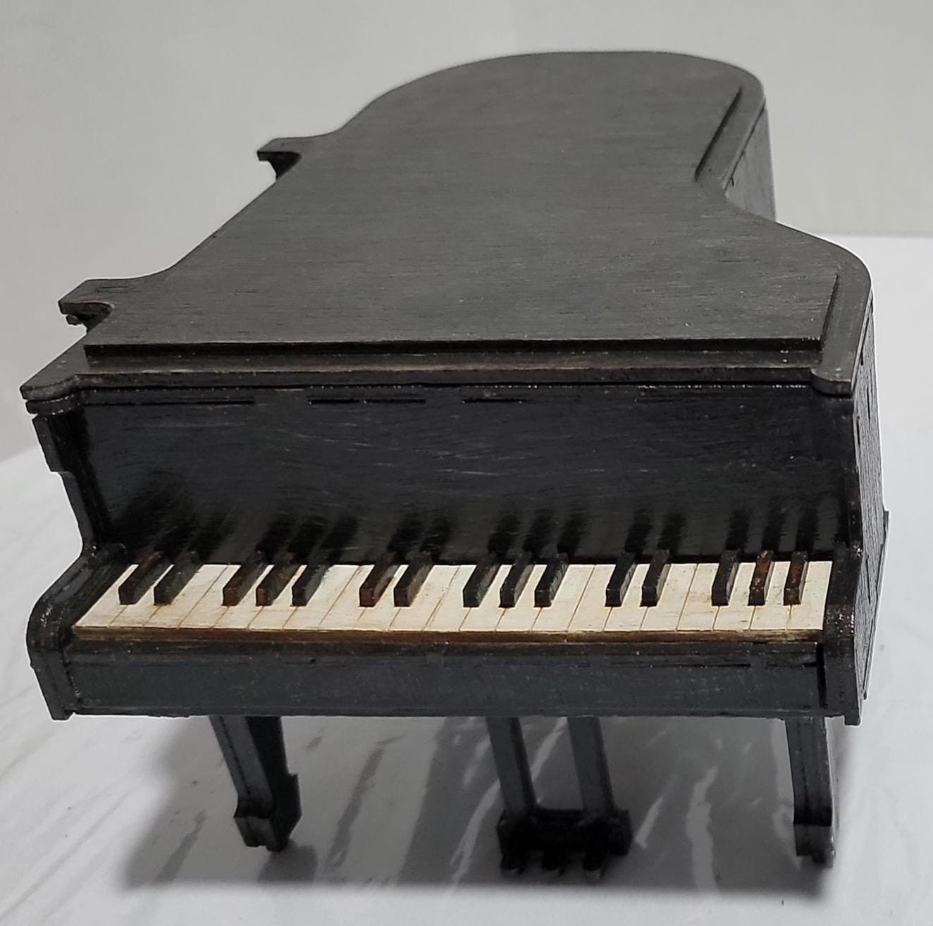 Don’t Miss This One-of-a-Kind Heirloom for Music Lovers
This isn’t just a gift — it’s a showstopper. A handcrafted miniature grand piano jewelry box that captures the soul of a concert hall in the palm of your hand. Designed for those who cherish music, memory, and craftsmanship, this piece is as rare as it is refined.
Meticulously made from solid MDF wood and sealed in a rich matte black finish, it features lifelike piano keys, pedals, and a hinged lid that opens to reveal a hidden jewelry compartment. 